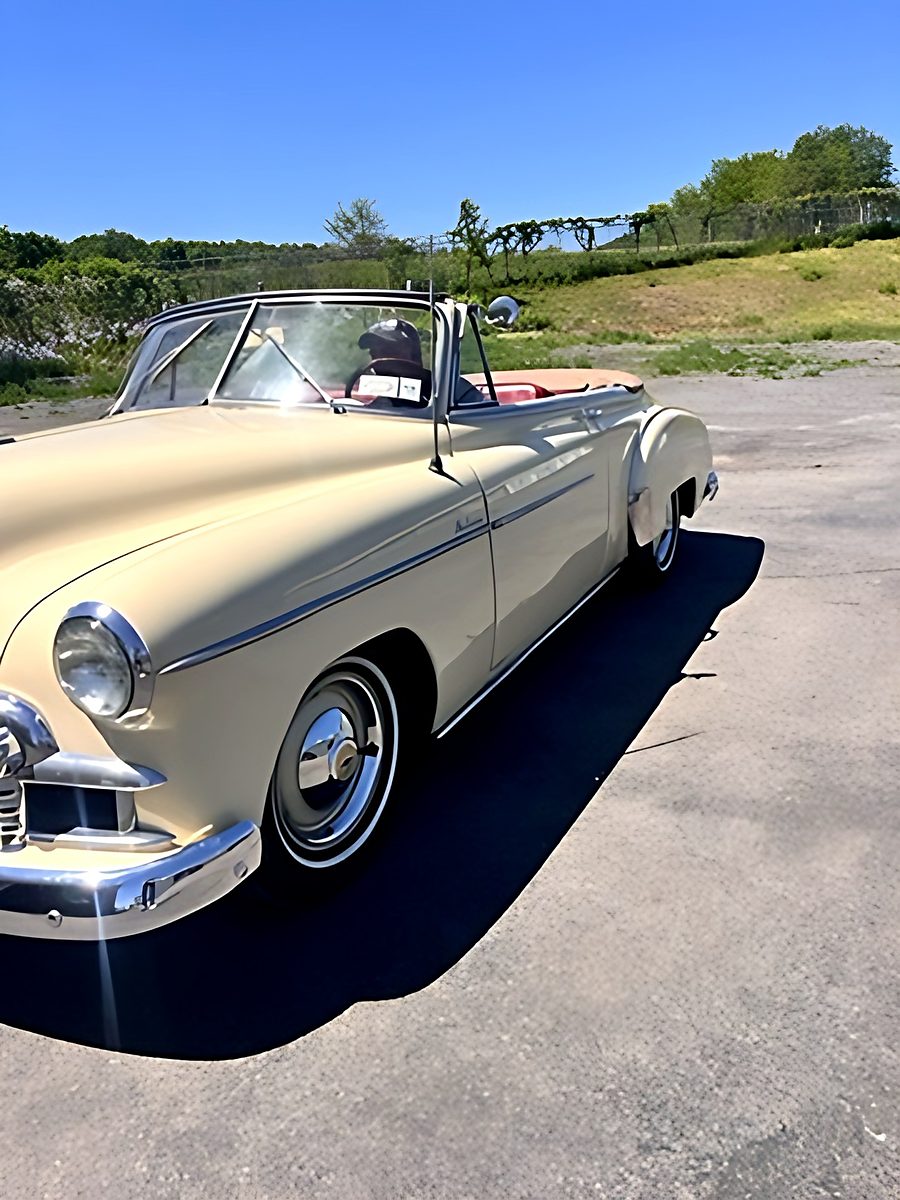 Cream convertible outside the shop