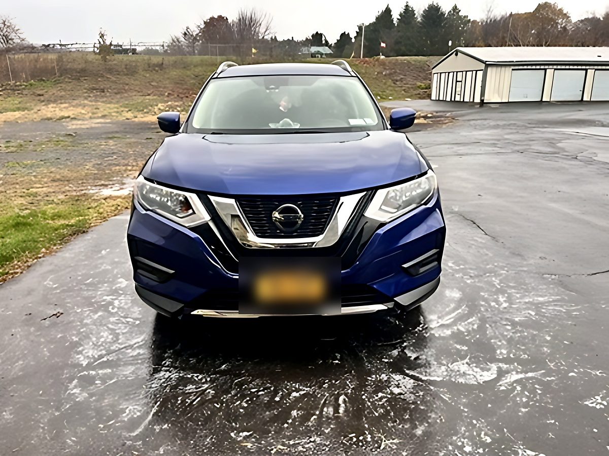 Blue Nissan Rogue after a wash