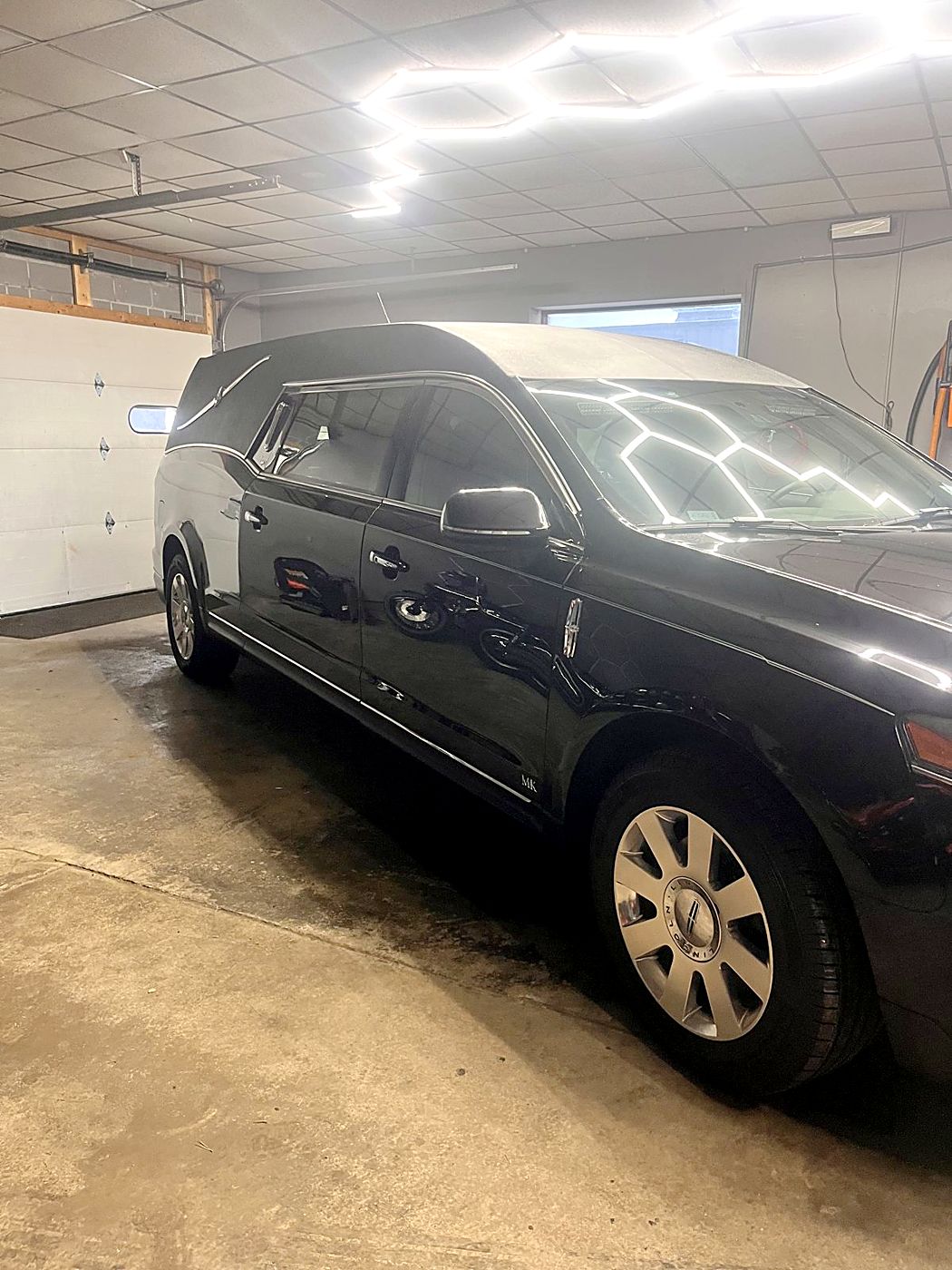 Black SUV under the hex lights